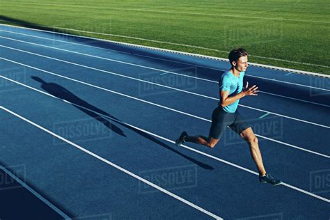 Shot Of A Young Male Athlete Training On A Race Track Sprinter Running