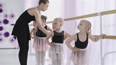 Group Of Little Girls Learning New Dance Moves During Ballet Lesson