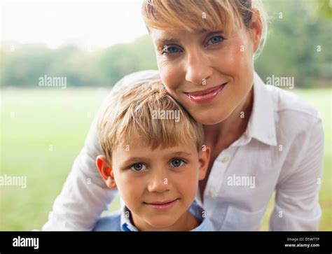 Smiling Mother Hugging Son Outdoors Stock Photo Alamy