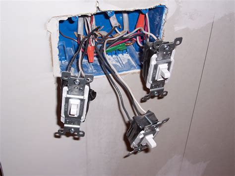 The hot source is spliced to the white wire (which should be marked as being hot with. File:Three light switches with exposed wiring.jpg - Wikimedia Commons