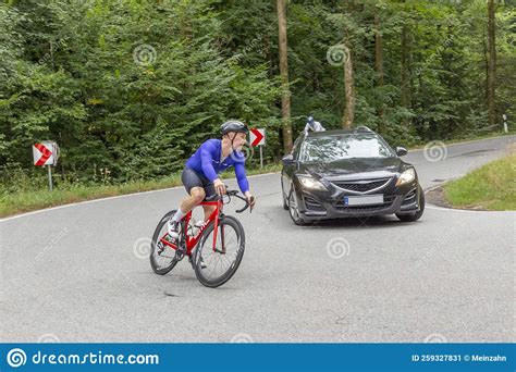 Bike Racer Of Team Superciao At An Orientation Race In Hesse Overtaking A Car Germany