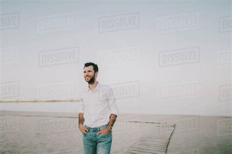 Caucasian Man Standing On Beach Stock Photo Dissolve