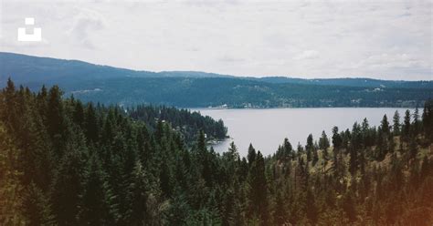 Lake Viewing Mountain Under White Skies During Daytime Photo Free