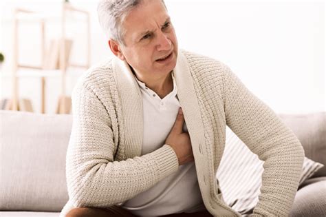 Mature Man With Chest Pain Suffering From Heart Attack Stock Photo