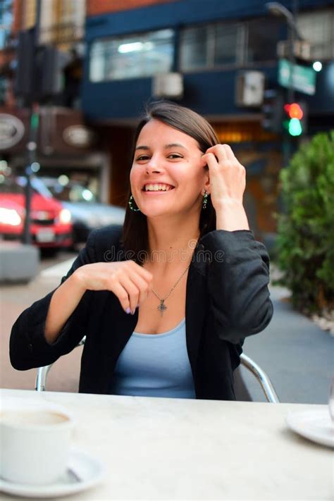 Smiling Confident Attractive Woman Sitting In A Outdoor Cafe Stock