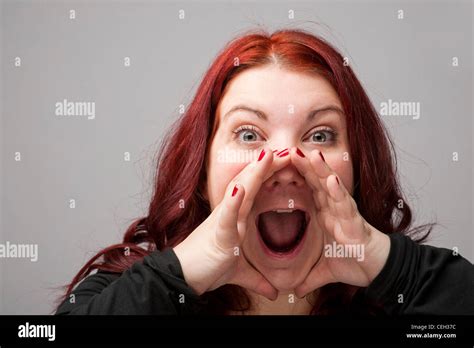 A Auburn Haired Caucasian Woman Yelling Shouting Screaming With Her