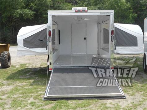 An Enclosed Trailer Parked In The Grass