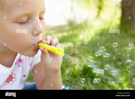 Little Girl Blowing Bubbles Outdoors Stock Photo Alamy
