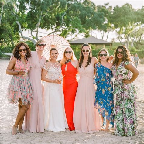 A Group Of Women Standing Next To Each Other On A Beach