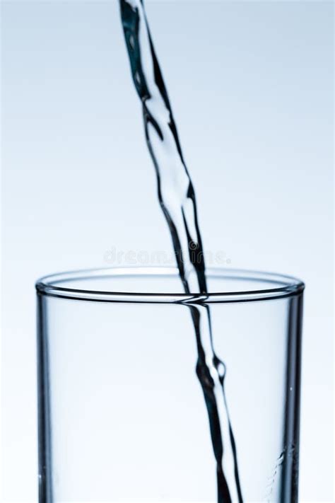 Pouring Water From A Bottle Into Glass Stock Photo Image Of Four