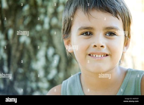 Little Boy Outdoors Smiling Head And Shoulders Portrait Stock Photo