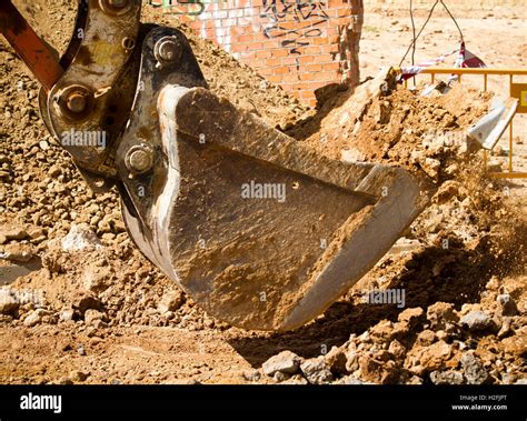 Excavator digging a deep trench Stock Photo - Alamy