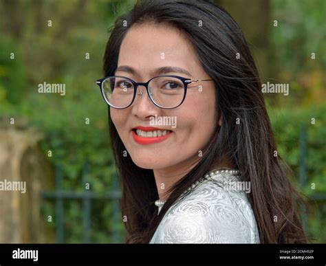 Young Asian Business Woman With Long Hair And Modern Eyeglasses Looks