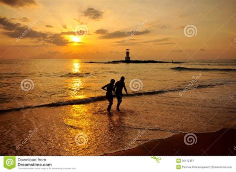 Silhouette Romantic Scene Of Couples On The Beach Royalty