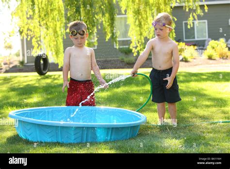 Young Boys Filling Swimming Pool Stock Photo Alamy