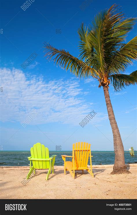 Summer Scene With Colorful Lounge Chairs On A Tropical