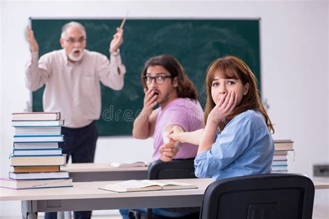 Old Chemist Teacher And Two Students In The Classroom Stock Image