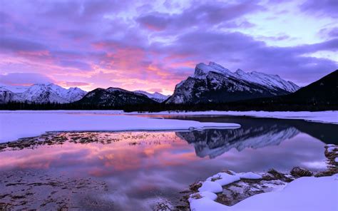 Pink Sunset And Clouds Over Winter Mountain And Lake