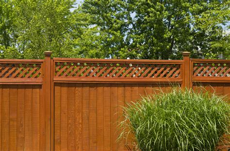 Chic stained wooden privacy fence and furniture that echoes that shade of stain. Top 8 Modern Wood Fence Design Ideas