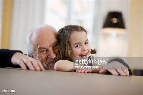 Old Man And Young Girl Smiling Photo Getty Images