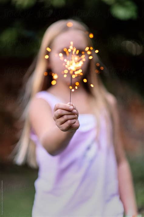 Girl With Outstretched Hand Holding A Sparkler By Angela Lumsden