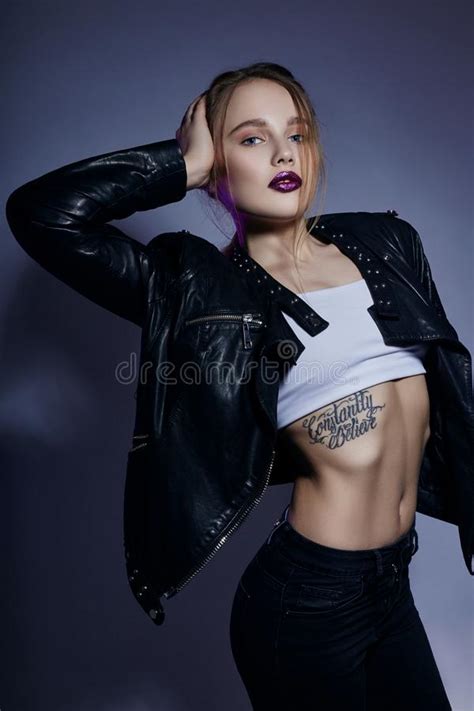 Blonde Girl With Tattoo In Leather Jacket And Jeans Portra Stock Image