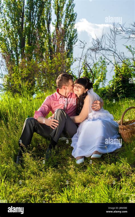 Beautiful Newlyweds Hugging At Park During Picnic Stock Photo Alamy