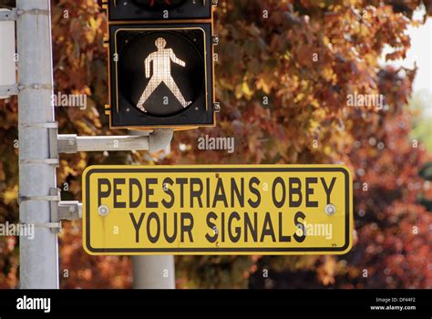 Street Signs Directing Pedestrians To Obey Traffic Signals Stock Photo