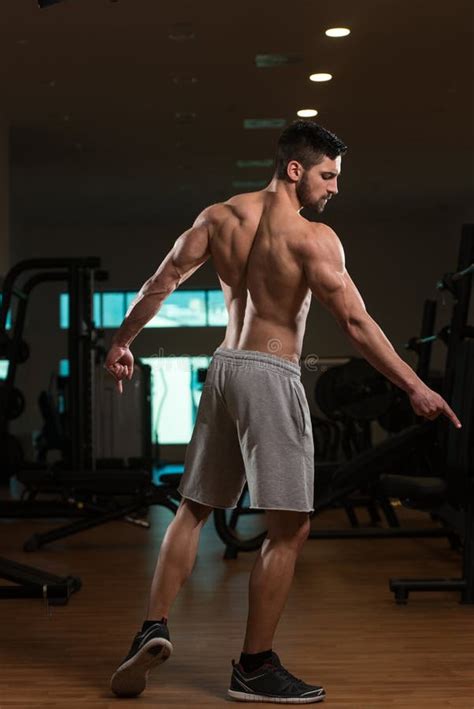 Muscular Man Flexing Muscles In Gym Stock Photo Image Of Clothing