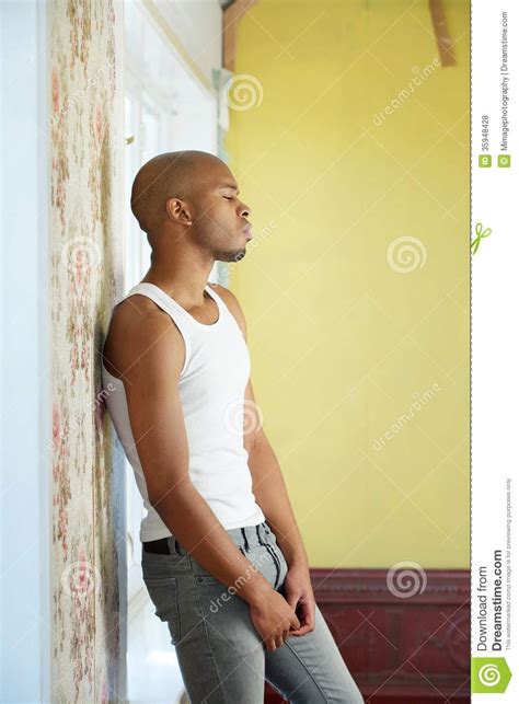 Portrait Of A Young Man Standing Alone At Home Stock Photo ...