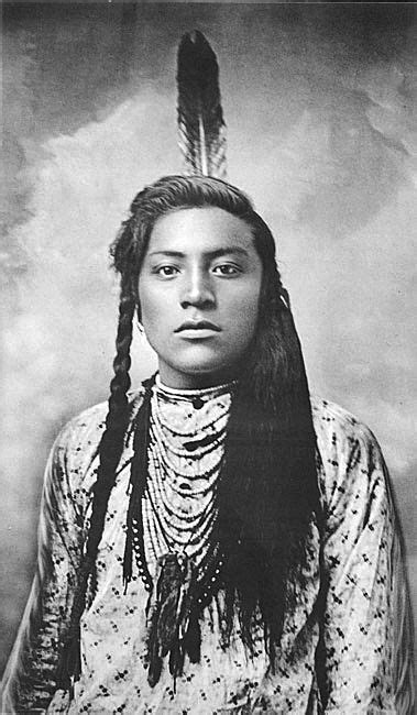 Native american (crow) man, identified as goes ahead, tending a fire. Young Curly or Curley (Ashishishe) (c1856-1923). Crow ...