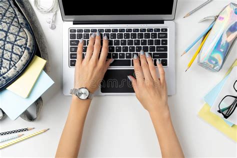 Females Hands Working On Modern Laptop With Backpack And Stationery