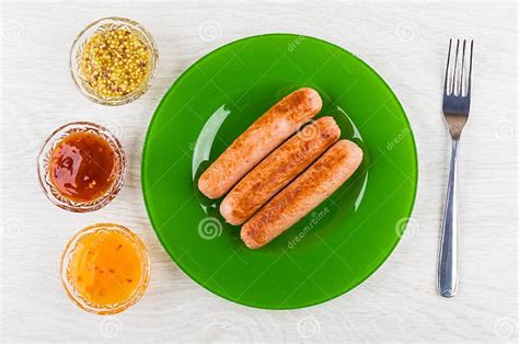 Fried Sausages In Plate Bowls With Ketchup Mustard Fork Stock Image