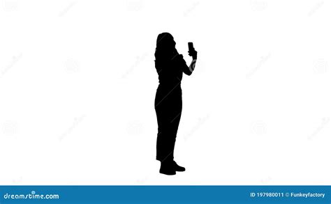Silhouette Blonde Woman Preening In Front Of The Smartphone Stock