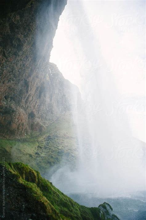 Standing Behind A Seljalandsfoss Waterfall In Iceland By Stocksy