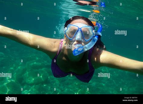 Woman With A Snorkel And Diving Goggles Scuba Diving In The Sea