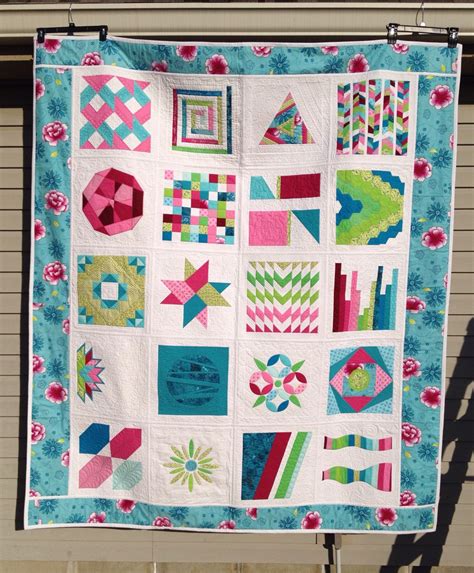 A Quilt Hanging On A Clothes Line With An Image Of Different Shapes And