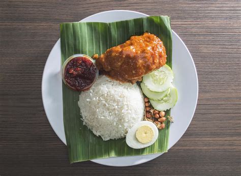 Nasi lemak is a dish originating in malay cuisine that consists of fragrant rice cooked in coconut milk and pandan leaf. Nasi Lemak Saleha_Nasi Lemak Rendang Ayam-min - EatDrink