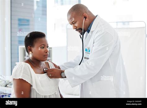 Mature Doctor Using A Stethoscope During A Consult African American