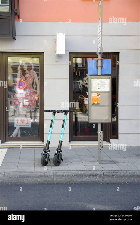 Parked Electric Scooters On A Sidewalk In Munichs Gärtnerplatz