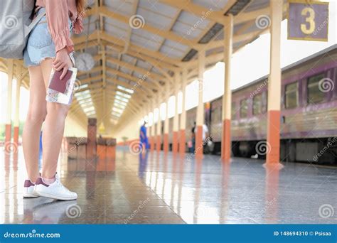 Woman Backpacker Traveler With Map Passport At Train Station While Waiting For Train Journey