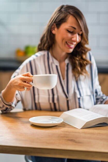 premium photo woman drinking coffee and reading book