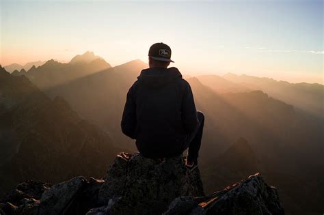 Man Sitting On The Mountain Edge · Free Stock Photo