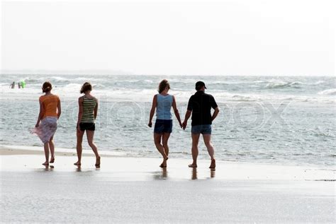 People Walking On The Beach A Bright Stock Image Colourbox