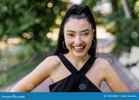 Portrait Of Smiling Attractive Asian Girl With Ponytail Black Hair