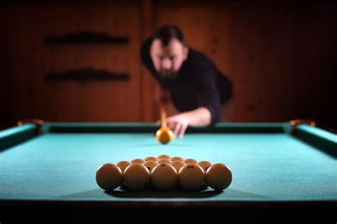 Premium Photo A Man With A Beard Plays A Big Billiard Party In 12 Foot Pool Billiards In The