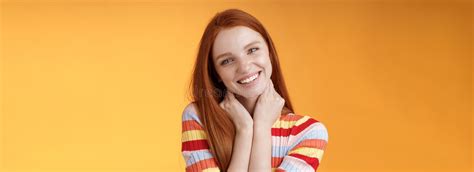 Silly Enthusiastic Attractive Redhead Blue Eyed Girl Tilting Head Touching Neck Flirty Smiling