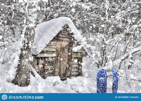 Little Old Wooden Hut In Winter Forest At Heavy Snowfall Stock Photo