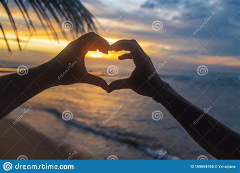 A Girl And A Man Make Hands A Heart At Sunset Sri Lanka Selective