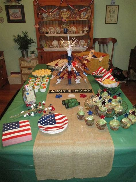 An Army Themed Table With Cupcakes And Flags